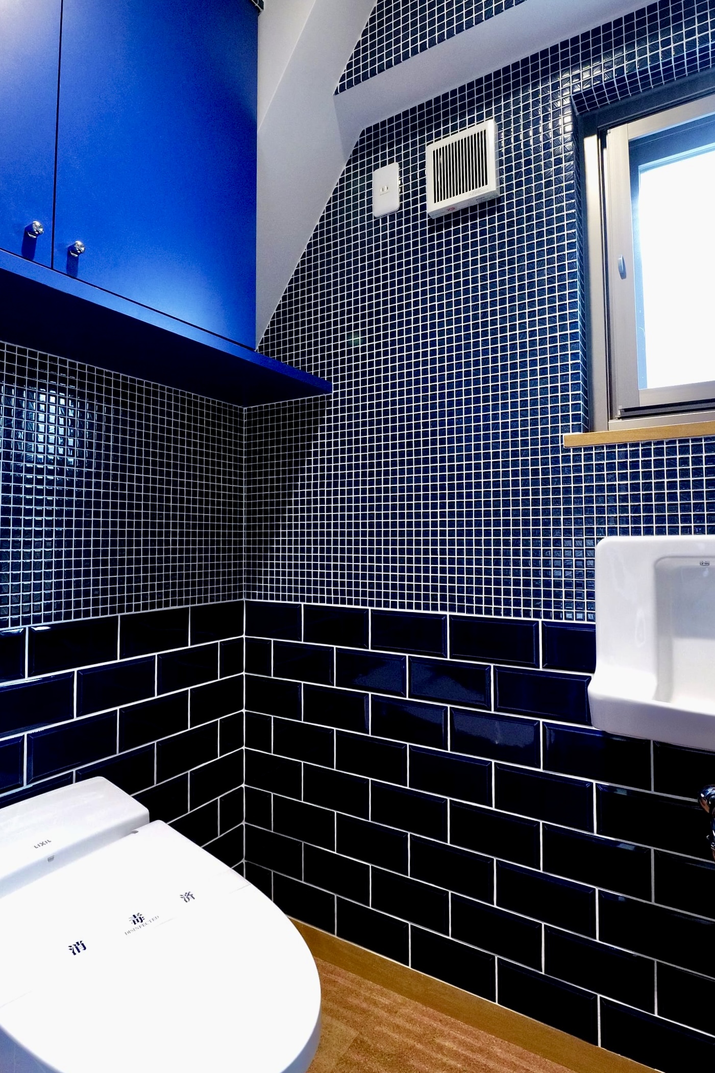 Royal-blue mosaic third-floor restroom